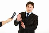 Very busy young businessman refusing to answer on phone call
