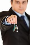 Young businessman holding keys in  hand
