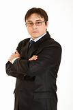 Serious young businessman with crossed arms on chest and eyeglasses
