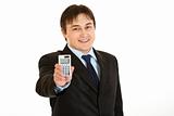 Smiling young businessman holding calculator in  hand
