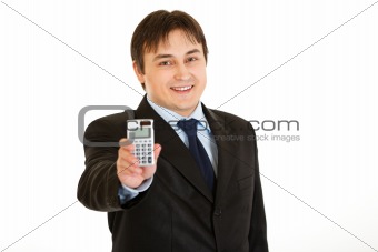 Smiling young businessman holding calculator in  hand
