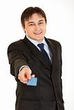 Smiling young businessman giving  credit card
