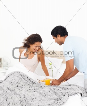 Attentive man bringing the breakfast for his girlfriend 