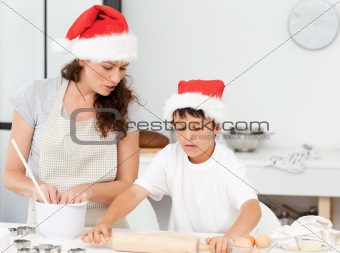 Mother and son preparing Christmas biscuits together