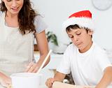 Cute boy preparing christmas biscuits with his mother