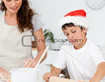 Cute boy preparing christmas biscuits with his mother