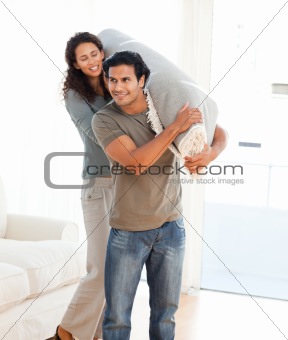 Man and woman carrying a carpet together