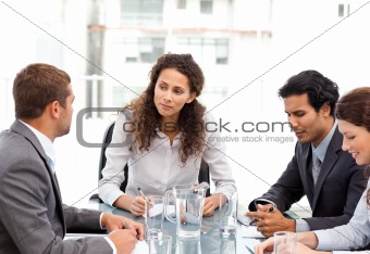 Beautiful manager speaking with her team during a meeting