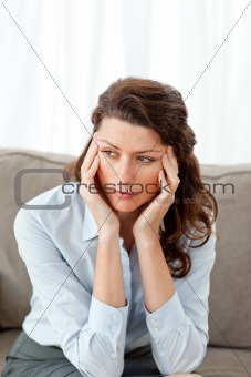 Exhausted businesswoman sitting on her sofa