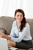 Beautiful businesswoman working with her laptop on the sofa
