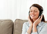 Happy businesswoman relaxing with music in the living-room