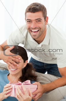 Cheerful man offering a present to his girlfriend
