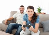 Concentrated woman playing video game with her boyfriend 