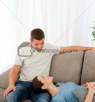 Happy couple relaxing together on the sofa