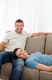 Portrait of a cheerful couple resting together on the sofa