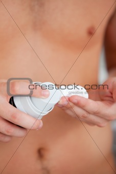 Close-up of a caucasian man preparing to shave in the bathroom