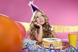 bored little blond girl birthday party with candle cake