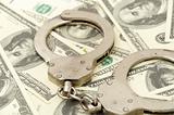 Handcuffs on money background,