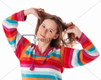 Young happy woman smiling grabs her hair
