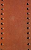 Rusty metal plate with rivets