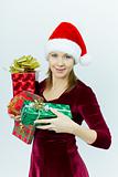 beautiful smiling girl in Santa hat with presents