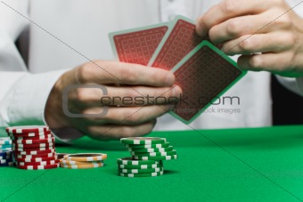 poker chips and the player's hand with the cards