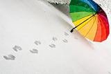Opened colorful umbrella in snow
