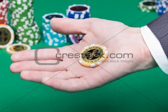 poker chips in the palm of a man