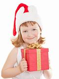 Baby girl in Santa's hat holding her Christmas present