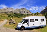 Camper van in mountains blue sky