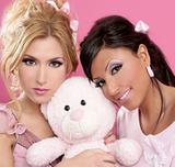 blonde and brunette girls hug a pink teddy bear
