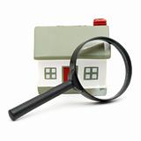 A magnifying glass examining model home