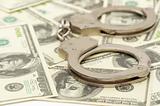 Handcuffs on money background,