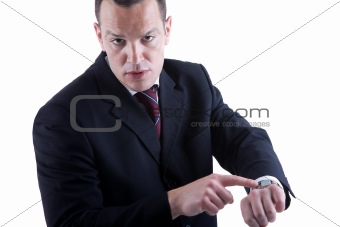 businessman pointing to the watch, isolated on white background. Studio shot.