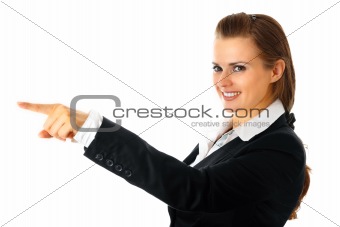 Smiling modern business woman pointing finger
