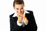 Smiling modern business woman showing thumbs up gesture
