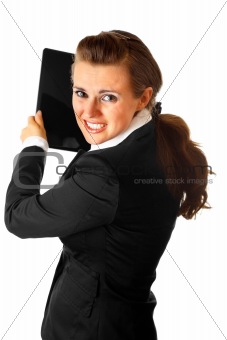 Stressed modern business woman brandishing laptop
