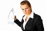 Angry modern business woman menacingly holding iron in hands
