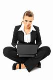 Laying on floor thoughtful modern business woman using  laptop
