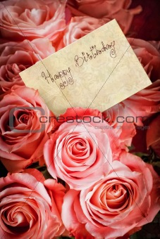 Pink roses with a greeting card