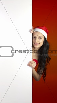 Sexy Christmas woman holding a sign