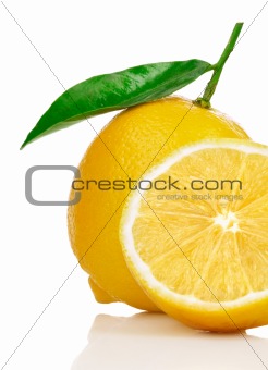 fresh lemons with cut and green leaves