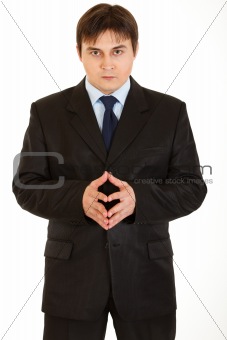 Concentrated young  businessman thinking about something

