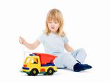 boy with long blond hair playing with a toy truck - isolated on white