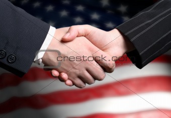 hand shake and a American flag in the background