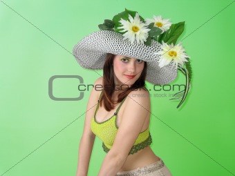 Beauty smiling girl with flowers in her hat