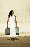 African American woman with suitcases.