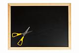 Chalkboard with yellow scissors