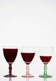 Glasses of red wine on a glass table