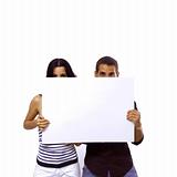 Teen couple holding a blank banner